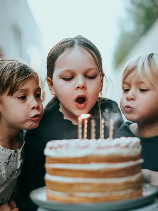 Children blowing out birthday candles