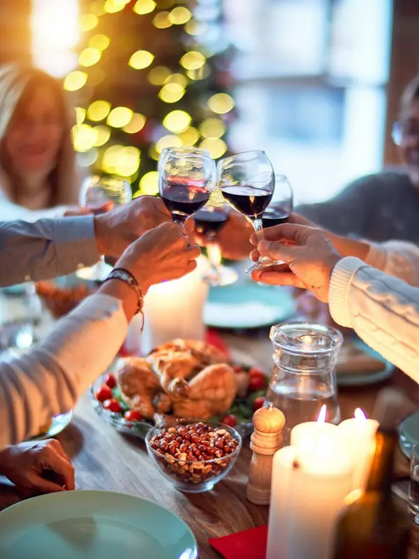 A toast around a candlelit festive dinner