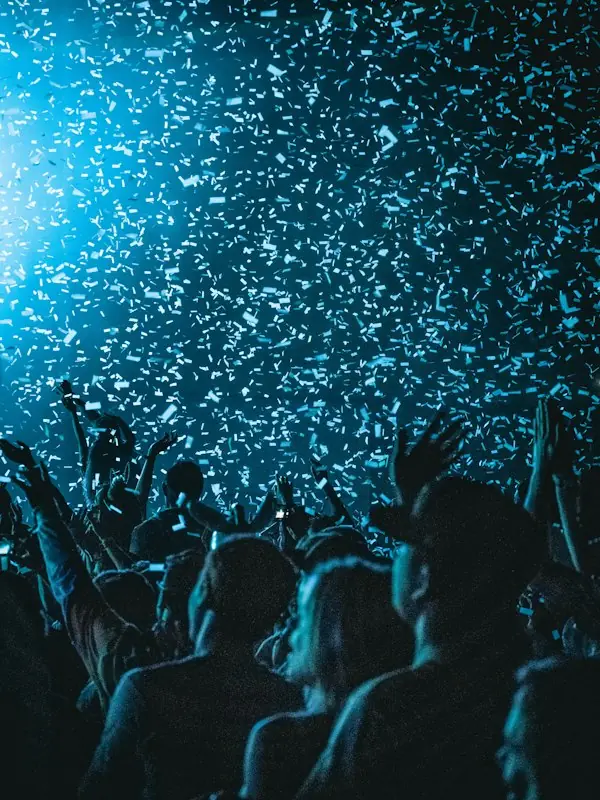 A crowd celebrating under a shower of confetti