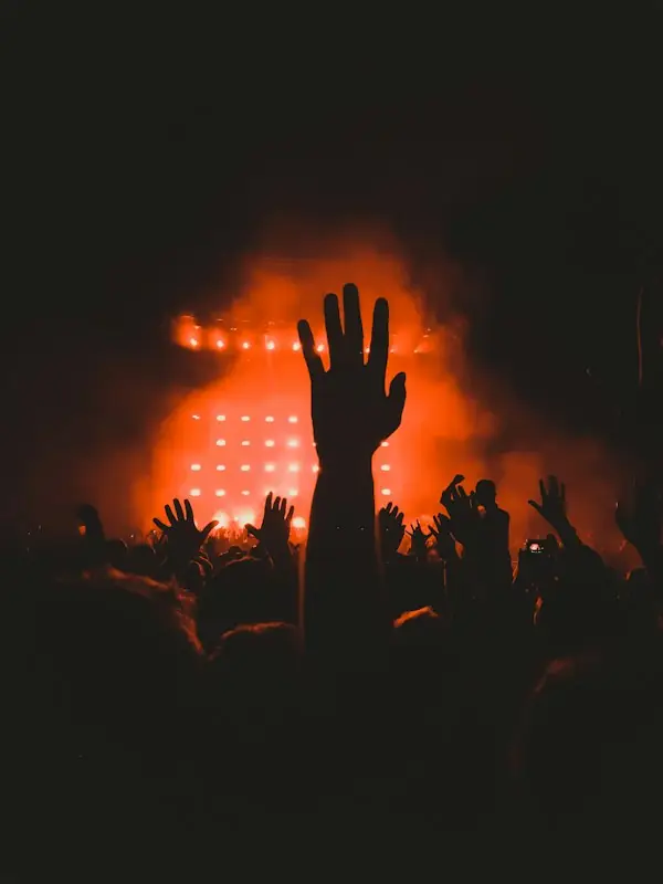 Hands in the air under warm stage lights